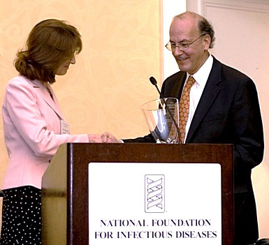 FIC director Dr. Roger Glass accepts the award presented by Dr. Susan J. Rehm, medical director of NFID.