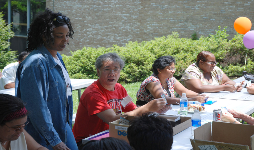 David Leung (above, third from l) calls out bingo letters and numbers at the Camp Fantastic BBQ on June 17.