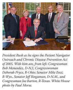 Photo of President George W. Bush signing the Patient Navigator Outreach and Chronic Disease Prevention Act of 2005. President Bush is seated at a desk. Standing behind him are, from left: Congressman Bob Menendez, Democrat-New Jersey; Congresswoman Deborah Pryce, Republican-Ohio; Senator Mike Enzi, Republican-Wyoming, Senator Jeff Bingaman, Democrat-New Mexico, and Congressman Joe Barton, Republican-Texas.