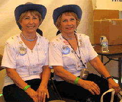 Twin volunteers relax in the NIDCD sign-up booth before having their hearing tested.
