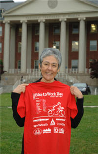 NIH deputy director Dr. Norka Ruiz Bravo displays event T-shirt, which she earned by pedaling from Takoma Park.