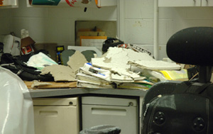 Ceiling tile debris litters the top of a work station in one of several Clinical Center areas damaged June 26 by flooding from a broken water pipe.