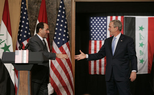 President George W. Bush reaches out to Iraqi Prime Minister Nouri al-Maliki Thursday, Nov. 30, 2006, following a joint press availability in Amman, Jordan. White House photo by Paul Morse