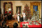 Mrs. Laura Bush and White House Chef Cris Comerford, center, explain the holiday reception menu to the press in the State Dining Room Thursday, Nov. 30, 2006. White House photo by Shealah Craighead