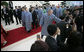 President George W. Bush reaches out to an onlooker as the leaders of the 2006 Asia-Pacific Economic Cooperation parade to APEC Island for their official portrait Sunday, Nov. 19, 2006, in Hanoi. White House photo by Eric Draper