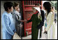 Mrs. Laura Bush is greeted as she arrives at the Temple of Literature in Hanoi Saturday, Nov. 18, 2006, for a tour with the spouses of APEC leaders. White House photo by Shealah Craighead