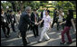 President George W. Bush greets passersby as he walks from Hanoi's Presidential Palace Friday, Nov. 17, 2006, to the Office of the Government where he met with Viet Prime Minister Nguyen Tan Dung. White House photo by Eric Draper