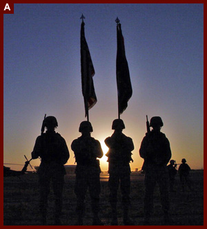 Four soldiers and flags during a ceremony honoring fallen soldier