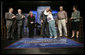 President George W. Bush is embraced by panel member Helen Robinette after concluding a conversation about Medicare prescription drug benefits at the Etta & Joseph Miller Performing Arts Center in Jefferson City, Mo., Tuesday, April 11, 2006. The President and Medicare and Medicaid Services administrator Mark McClellan, far left, met with several Missourians. They are, from left, Gerald Sooter, Jodie Baker, Helen Robinette, Bob Vanderfeltz and Linda Detring. White House photo by Eric Draper