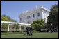 President George W. Bush walks across the Rose Garden with Al Hubbard of the National Economic Council, left, and Ed Lazear of the Council of Economic Advisors, after addressing the press Friday, April 28, 2006. White House photo by Paul Morse