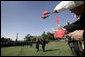 Guests wave flags for Presidents George W. Bush and Hu Jintao during an arrival ceremony held on the South Lawn for the Chinese President, Thursday, April 20, 2006. White House photo by Eric Draper