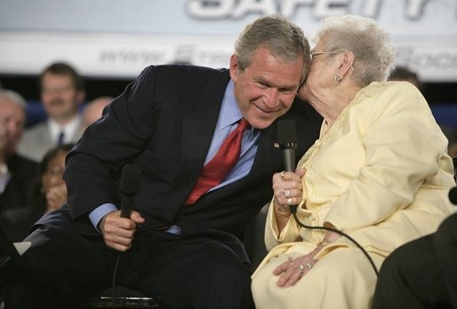 President George W. Bush leans in for a whisper from Cecil Ferrell, founder and owner of Ferrell’s Hamburgers in Hopkinsville, Ky., one of the participants in the President's Conversation on Strengthening Social Security Thursday, June 2, 2005, at the Hopkinsville Christian County Conference and Convention Center. White House photo by Eric Draper