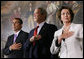 President George W. Bush stands with House Minority Leader John Boehner and Speaker of the House Nancy Pelosi for the playing of the National Anthem Thursday, March 29, 2007, during Congressional Gold Medal ceremonies honoring the Tuskegee Airmen. White House photo by Eric Draper