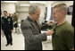 President George W. Bush presents the Purple Heart to U.S. Marine Lance Cpl. Joshua Ryan Bleill of Greenfield, Ind., during a visit Friday, March 30, 2007, to the Walter Reed Army Medical Center in Washington, D.C. Bleill is recovering from injuries sustained in Operation Iraqi Freedom. White House photo by Eric Draper