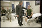 President George W. Bush talks with U.S. Marine Corps Bradley Jerome Walker of White Pine, Tenn., Friday, March 30, 2007, during a visit to Walter Reed Army Medical Center in Washington, D.C. White House photo by Eric Draper