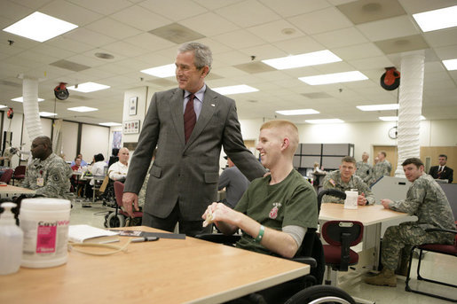 President George W. Bush talks with U.S. Marine Corps 2nd Lt. Andrew Kinard of Spartanburg, S.C., Friday, March 30, 2007, during a visit to Walter Reed Army Medical Center in Washington, D.C. White House photo by Eric Draper