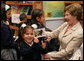 A little girl holds up a picture of Mrs. Bush's cat, Willie, during Mrs. Bush's visit to Rafael Pombo Foundation Sunday, March 11, 2007, in Bogotá, Colombia. White House photo by Shealah Craighead