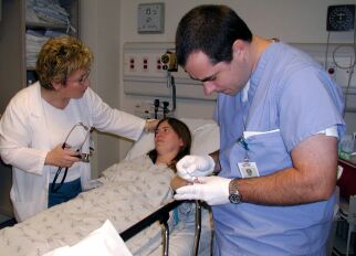 Female patient in the ER receiving a finger prick