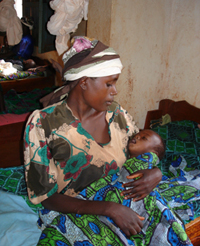 Mother cradling sick child in her arms, Tanzania.