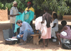 Dr. Steve Smith, CDC, uses a portable X-ray fluorescence analyzer to measure the content of insecticide in an insecticide-treated bednet in rural Ghana.