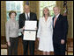 President George W. Bush and Mrs. Bush present the Preserve America award for private preservation to Arthur Tauck, Jr., Chairman of the Board, and his daughter Robin Tauck, President and CEO, both of Tauck World Discovery , in the Oval Office Monday, May 1, 2006. The company began a volunteer program for Yellowstone National Park in Montana, Idaho and Wyoming. White House photo by Eric Draper