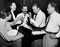 Desi Arnaz, Vera Vague, Jerry Colona, Bob Hope and Wendell Niles rehearse for a 1946 radio program.