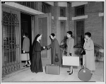 A nun greeting three female students