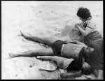 Three people laying on the Atlantic City beach