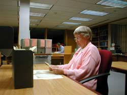 A volunteer working in the archival collection