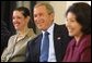 President George W. Bush listens to a suggestion with panelists Carmen Agiuar, left, and Delia Garcia at the Corporate Responsibility discussion panel at the President's Economic Forum held at Baylor University in Waco, Texas on Tuesday August 13, 2002. 