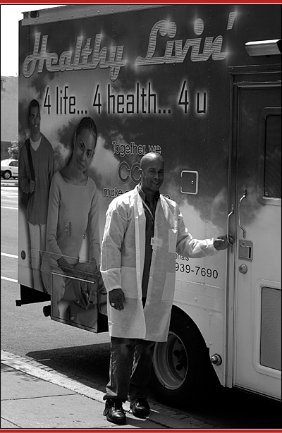 Photo of guy in front of the "Healthy Livin" van.