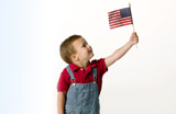A little boy holding the American Flag