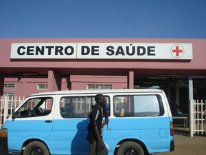 Photo of a man walking in front of the Centro de Saude, a new health clinic in Luanda.