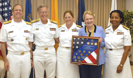 The acting surgeon general and HRSA's flag officers present Dr. Duke with a memento of appreciation for her support of the Corps. Pictured are Galson, Weaver, Nesseler, Duke, and Parham Hopson.