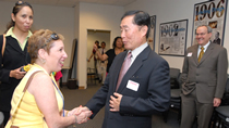 HRSA employee Dena Saunders greets George Takei at the presentation.