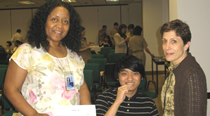 Hahn Liu, from the Division of Transplantation, takes the simple cheek-swab test to join the National Marrow Donor Registry. Gina Boyd, NIH Donor Center Recruiter, and Robyn Ashton, also with DOT, helped coordinate the event.