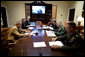 President George W. Bush speaks during a video teleconference with Vice President Dick Cheney, on screen, and military commanders in the Roosevelt Room of the White House, Saturday, Oct. 21, 2006. Pictured from left are National Security Advisor Stephen Hadley, Deputy National Security Advisor J.D. Crouch, Senior Advisor to the Secretary of State on Iraq David Satterfield, Secretary of Defense Donald Rumsfeld, U.S. Army General John Abizaid and Chairman Joint Chiefs of Staff U.S. Marine General Peter Pace. White House photo by Eric Draper