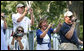 Families root for their kids as they also document the All-Star tee-ball action at the White House, July 16, 2008 – a hot Wednesday afternoon in Washington, D.C. One child represented each state and the District of Columbia in the action on the South Lawn, which was attended by both President George W. Bush and Mrs. Laura Bush. White House photo by Shealah Craighead