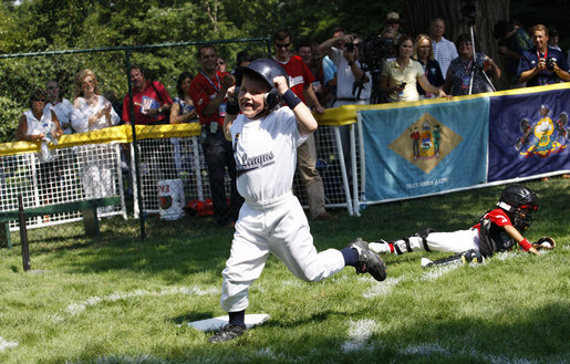 Five-year-old Alex Thaler of the Eastern U.S. All-Stars makes a valiant effort as Jackson McGough of the Central U.S. All-Stars crosses the plate Wednesday, July 16, 2008, during All-Star Tee Ball at the White House. Players from across the United States gathered for the first time on the White House lawn to play the doubleheader that matched the Southern U.S. against the Western U.S. in the second game. White House photo by Eric Draper