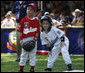 Kelsey Brauer of the Central U.S. Tee Ball All-Stars leans into first baseman Connor Hogan of the Eastern U.S. All-Stars after reaching first Wednesday, July 16, 2008, during the first game of an All-Star Tee Ball doubleheader on the South Lawn of the White House. White House photo by Eric Draper