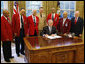 President George W. Bush is joined by members of the Tuskegee Airmen, Joint Chiefs Chairman Admiral Michael Mullen, center-background, and Department of Veterans Affairs Secretary James Peake, right, as he signs a Presidential Proclamation in honor of the 60th Anniversary of Armed Forces Integration, Wednesday, July 23, 2008 in the Oval Office at the White House.  White House photo by Eric Draper