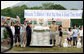 Flag-waving youngsters and a snowman welcome the G-8 Spouses to Makkari Tuesday, July 8, 2008, where they visited a farmer's market and participated in a luncheon hosted by Mrs. Kiyoko Fukuda, spouse of Japan's Prime Minister Yasuo Fukuda, host of the 2008 G-8 Summit. White House photo by Shealah Craighead