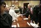 President George W. Bush exchanges handshakes with Mr. Mohammed Jaber during a visit at the White House Wednesday, Jan. 18, 2006, with victims of Saddam Hussein. Mr. Jaber is a former Iraqi journalist who was jailed for writing a story that raised questions about how oil money was being spent.  White House photo by Eric Draper