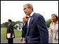 Flanked by interpreters, President George W. Bush and Italian Prime Minister Silvio Berlusconi leave a news conference after Berlusconi's arrival at Camp David, Saturday, Sept. 14, 2002. WHITE HOUSE PHOTO BY ERIC DRAPER  
