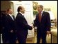 President George W. Bush greets Russian Foreign Minister Igor Ivanov, center, and Russian Defense Minister Sergei Ivanov, left, as they walk into the Oval Office, Friday, Sept. 20, 2002.  