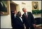 President George W. Bush welcomes President Omar Bongo Ondimba of Gabon to the Oval Office Wednesday, May 26, 2004.  White House photo by Eric Draper