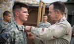 U.S. Navy Adm. Mike Mullen, chairman of the Joint Chiefs of Staff, awards the Silver Star to U.S. Army Capt. Gregory Ambrosia, Korengal Outpost, Afghanistan, July 11, 2008.