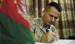 Chairman of the Joint Chiefs of Staff U.S. Marine Gen. Peter Pace writes a message and signs a guest book after visiting the Afghan military training facility in Kabul, Afghanistan, April 21, 2007.