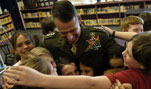 U.S. Marine Gen. Peter Pace, chairman of the Joint Chiefs of Staff, receives a group hug after answering questions and visiting fifth-grade students at Marshall Elementary School in Vancouver, Wash., Feb. 21, 2007.