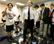 Acting Surgeon General Steven  K. Galson joins students in a game at Nautilus Middle School in the wellness center.